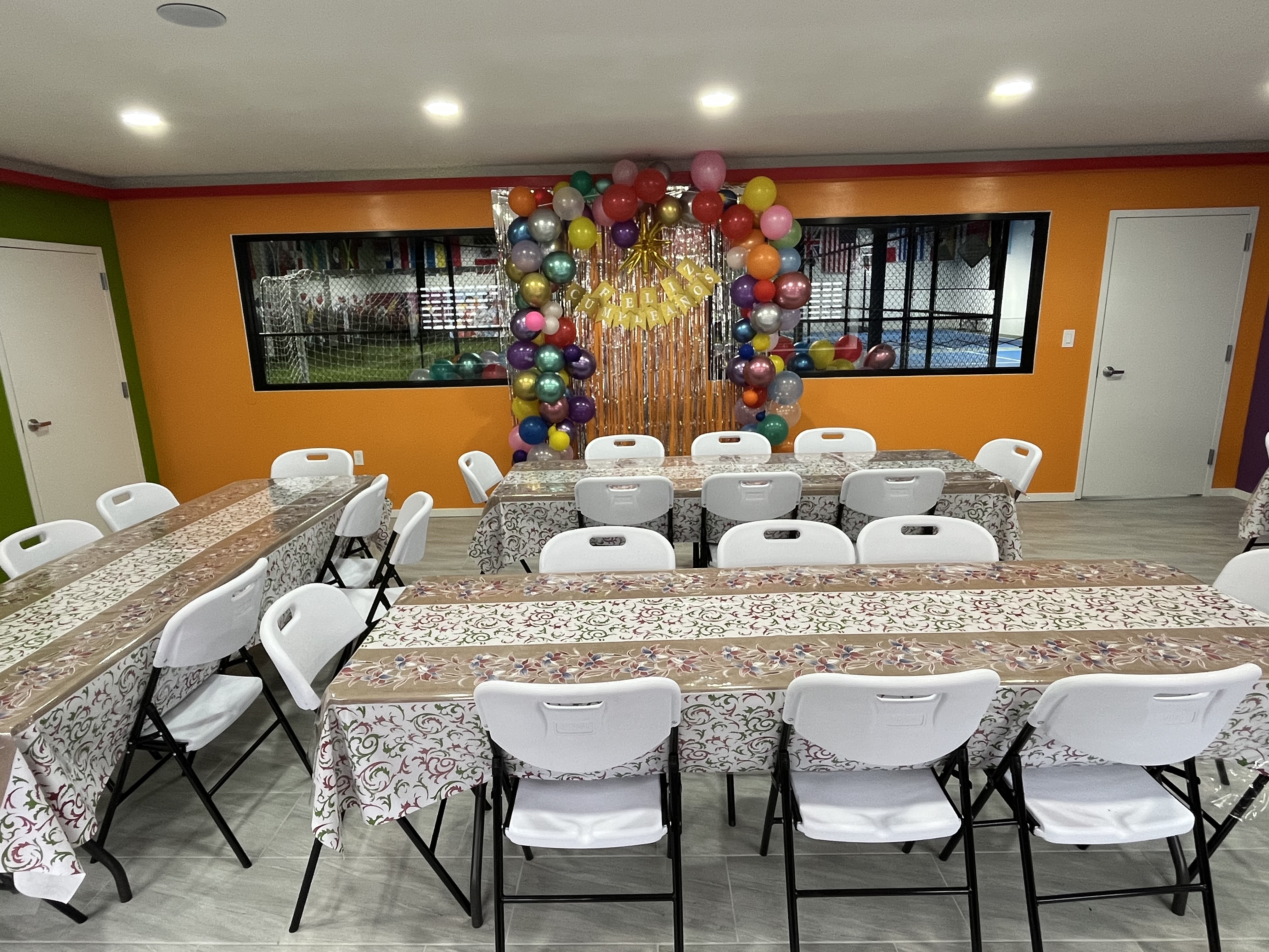 Event room decorated with colorful balloons for a birthday party