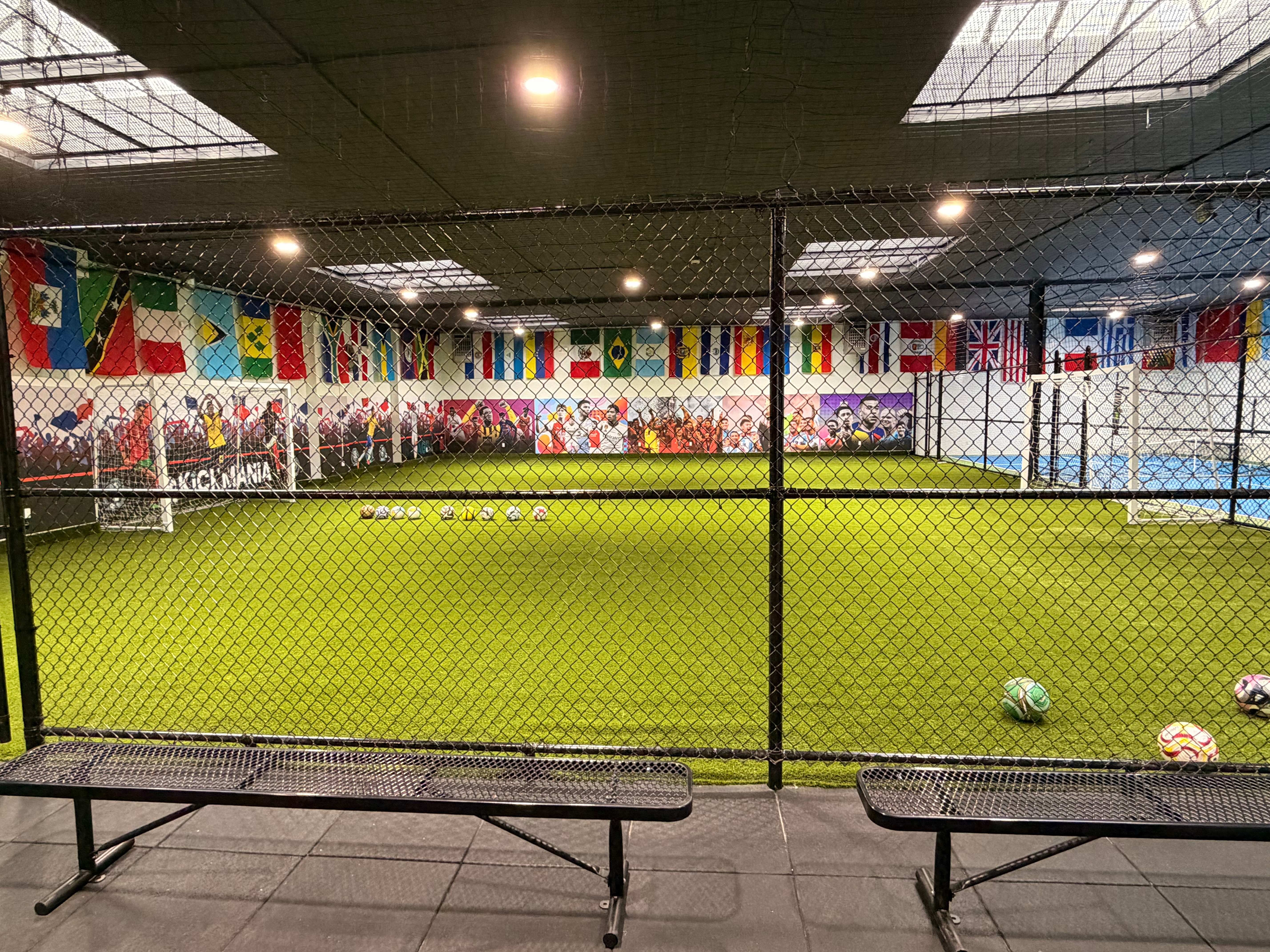 View of the futsal court from the spectator benches through the fence