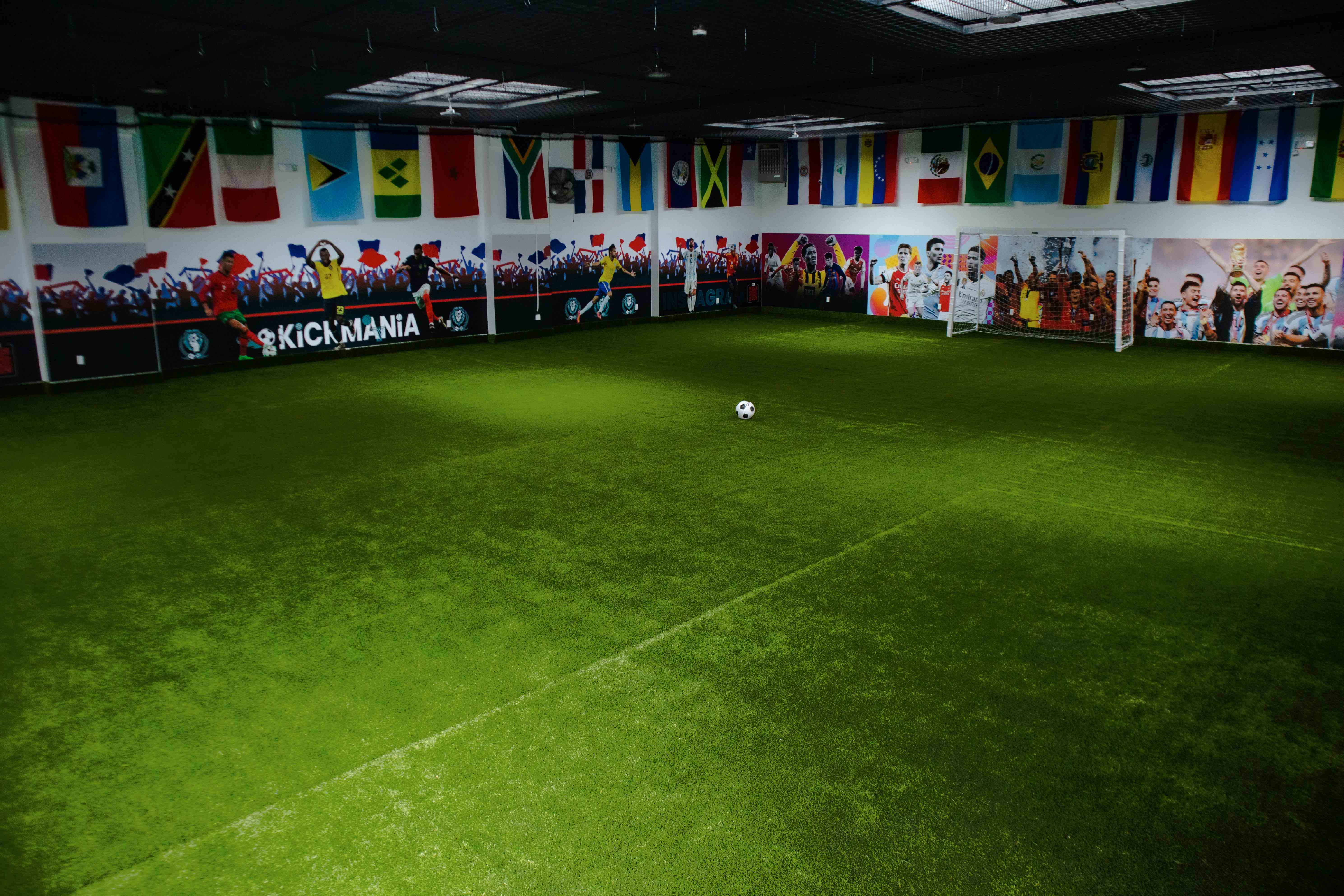 Empty futsal field with a ball at center and goals at each end